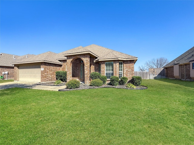 view of front of property featuring a garage and a front yard