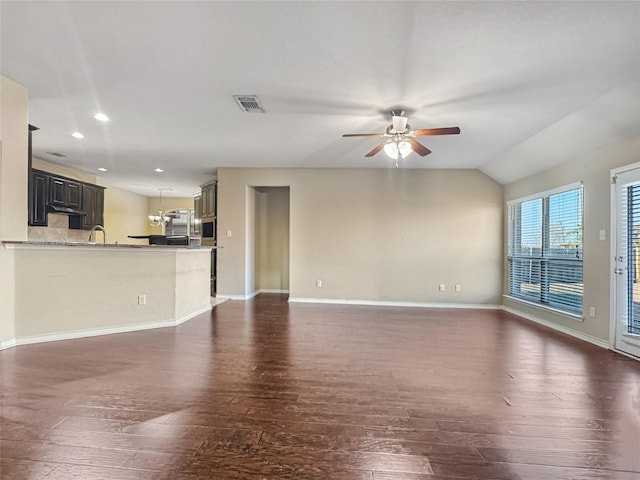 unfurnished living room with ceiling fan, lofted ceiling, sink, and dark hardwood / wood-style flooring