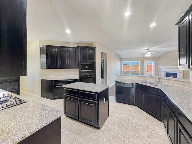 kitchen featuring light tile patterned flooring, sink, tasteful backsplash, a center island, and black dishwasher