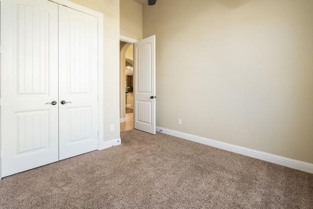 unfurnished bedroom with carpet floors and a closet