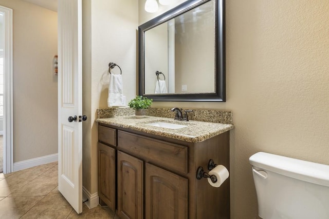 bathroom featuring vanity, toilet, and tile patterned flooring