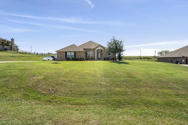 single story home featuring a front lawn