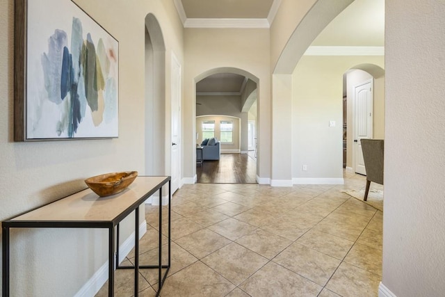 hall featuring crown molding and light tile patterned floors