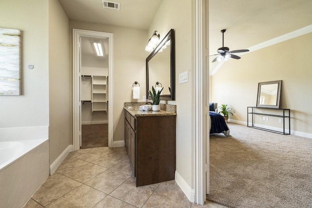 bathroom featuring crown molding, ceiling fan, vanity, a tub to relax in, and tile patterned floors