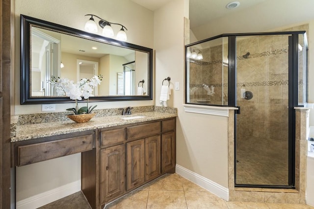 bathroom featuring vanity, tile patterned floors, and walk in shower