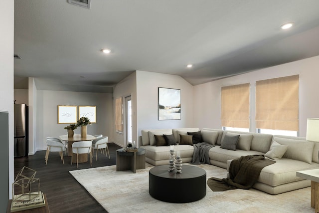 living area with vaulted ceiling, recessed lighting, wood finished floors, and visible vents