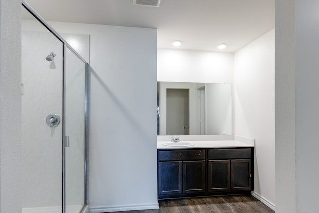 bathroom with vanity, hardwood / wood-style floors, and walk in shower