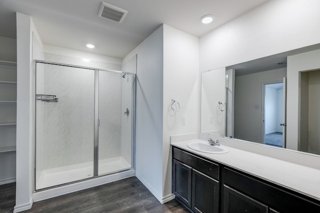 bathroom featuring vanity, hardwood / wood-style floors, and walk in shower