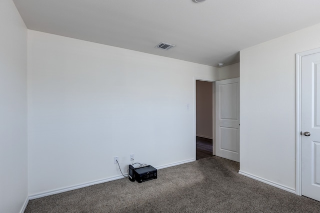 unfurnished room with dark carpet