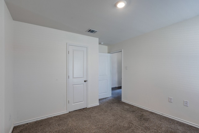 unfurnished bedroom featuring dark colored carpet