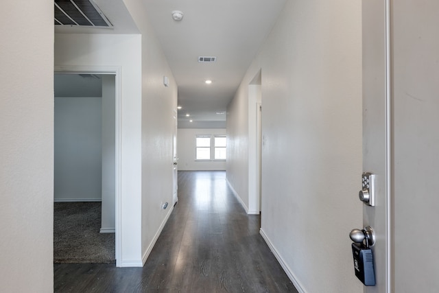 corridor with visible vents, recessed lighting, baseboards, and wood finished floors