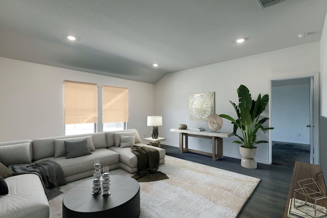 living room featuring vaulted ceiling and dark hardwood / wood-style flooring