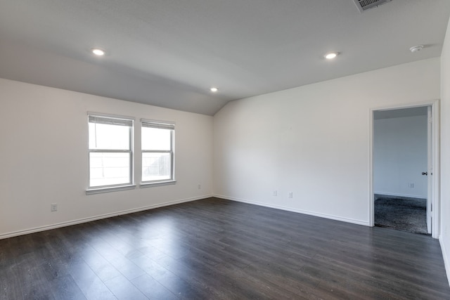 unfurnished room with vaulted ceiling and dark hardwood / wood-style flooring