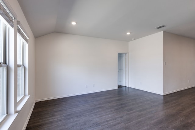 unfurnished room featuring lofted ceiling and dark wood-type flooring