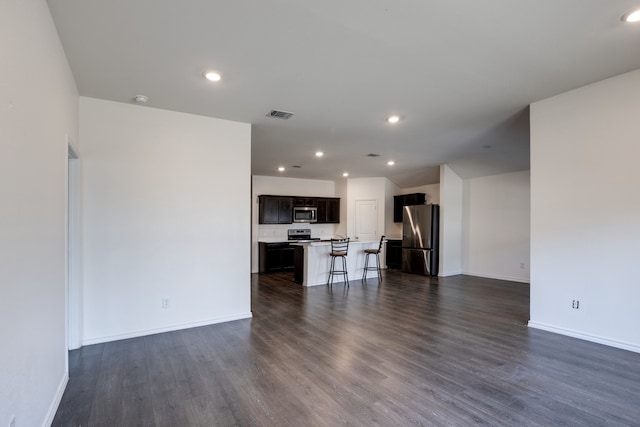 3316 Buttonbush Dr, Royse City, TX 75189 - unfurnished living room featuring dark wood-style flooring, baseboards, and recessed lighting