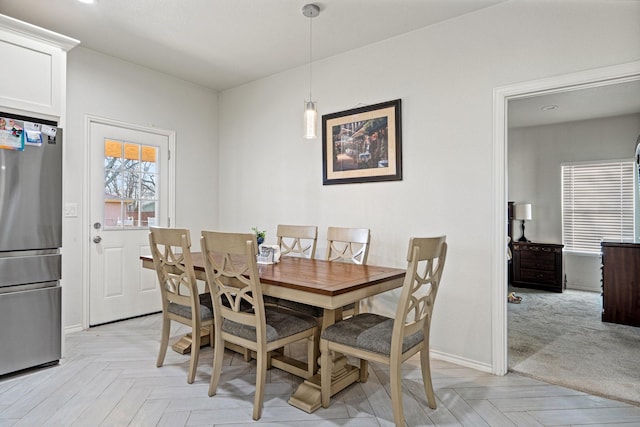 dining space with light parquet flooring