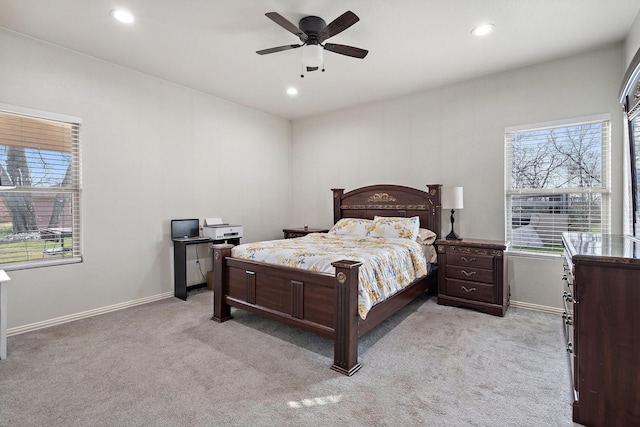 carpeted bedroom with multiple windows and ceiling fan