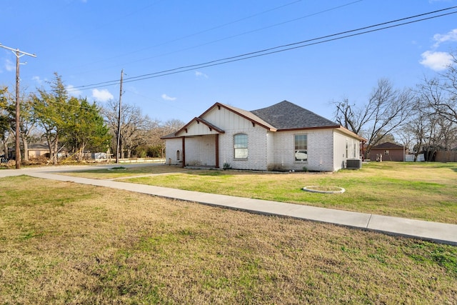 view of front of property with a front yard and central AC unit