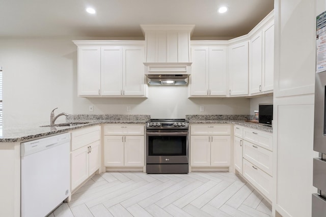 kitchen with sink, light stone counters, electric range, white dishwasher, and light parquet floors