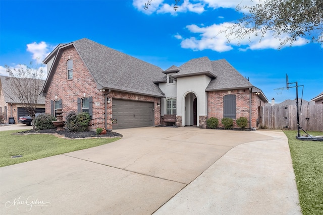 view of front of house with a garage and a front lawn