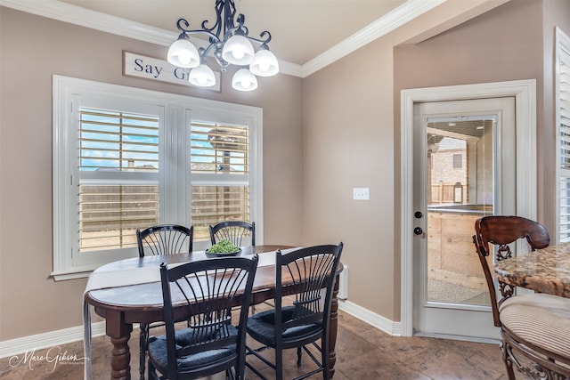 dining room with ornamental molding and a chandelier