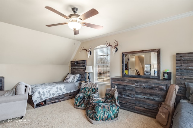 carpeted bedroom featuring ceiling fan, ornamental molding, and vaulted ceiling