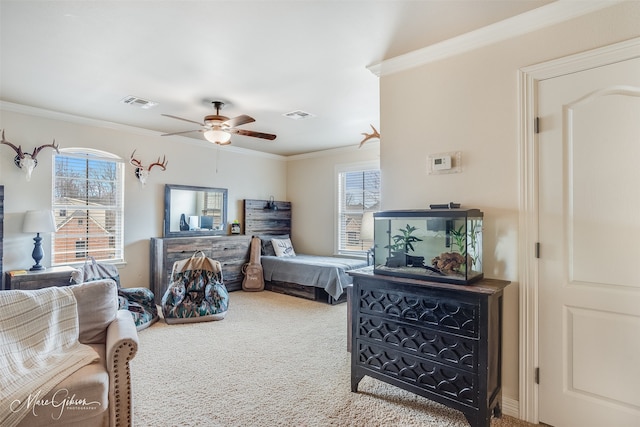 bedroom with ornamental molding, carpet flooring, and ceiling fan