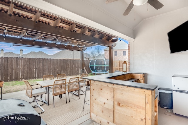 view of patio / terrace featuring ceiling fan and an outdoor bar