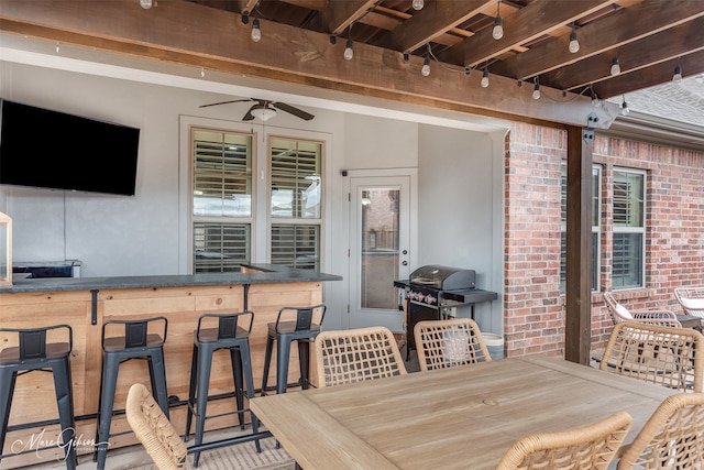 view of patio / terrace featuring ceiling fan, a grill, and an outdoor bar