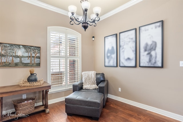 living area with crown molding, dark hardwood / wood-style flooring, and an inviting chandelier