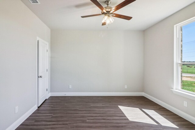 kitchen with white cabinetry, sink, stainless steel appliances, dark wood-type flooring, and a center island with sink