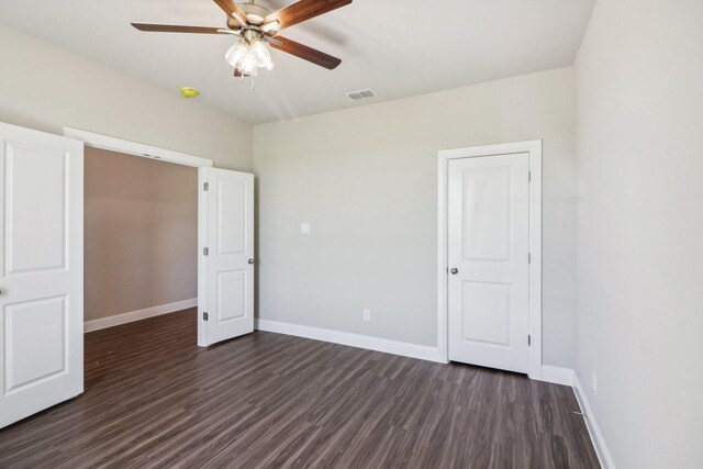 spare room featuring ceiling fan and dark hardwood / wood-style flooring