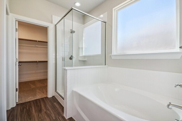 bathroom featuring vanity, wood-type flooring, and walk in shower