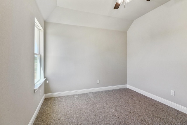 carpeted empty room with ceiling fan and vaulted ceiling