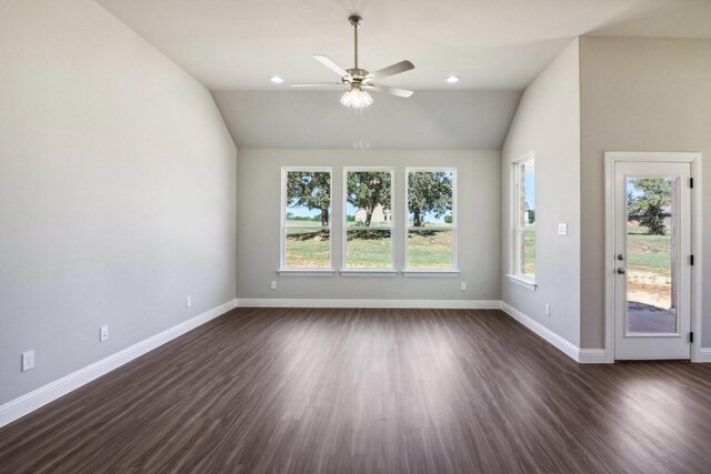 unfurnished living room with lofted ceiling, ceiling fan with notable chandelier, and dark hardwood / wood-style flooring