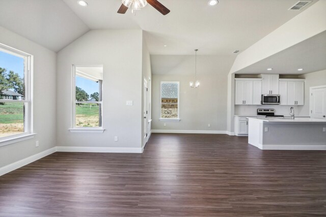 spare room featuring dark wood-type flooring, ceiling fan, and lofted ceiling