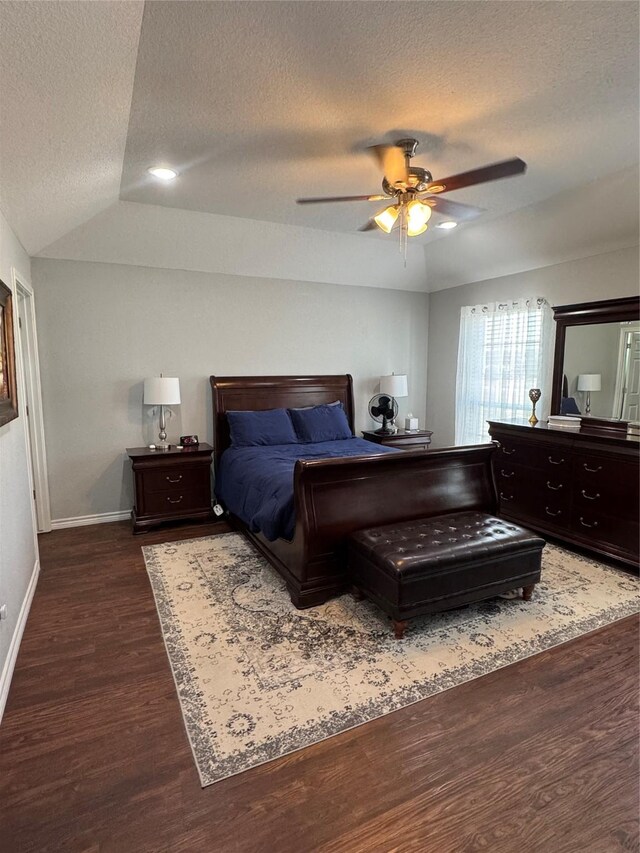 1006 High Point Dr, Mineral Wells, TX 76067 - bedroom with a textured ceiling, dark wood-style flooring, baseboards, lofted ceiling, and a ceiling fan