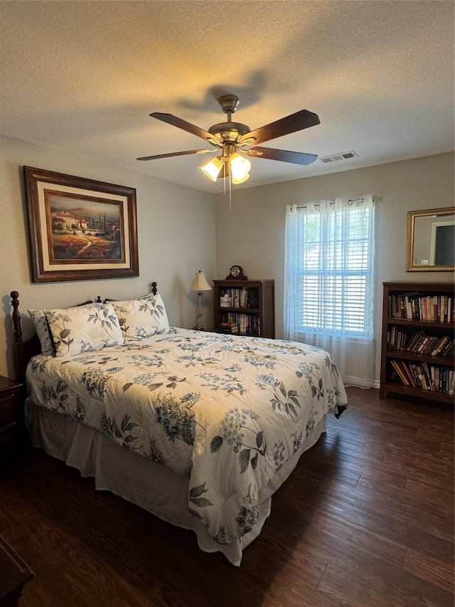 1006 High Point Dr, Mineral Wells, TX 76067 - bedroom with dark wood-type flooring, a textured ceiling, baseboards, and a ceiling fan