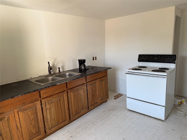 kitchen with white range with electric cooktop, sink, and light hardwood / wood-style flooring