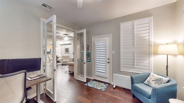 home office featuring dark hardwood / wood-style floors, radiator heating unit, and ceiling fan