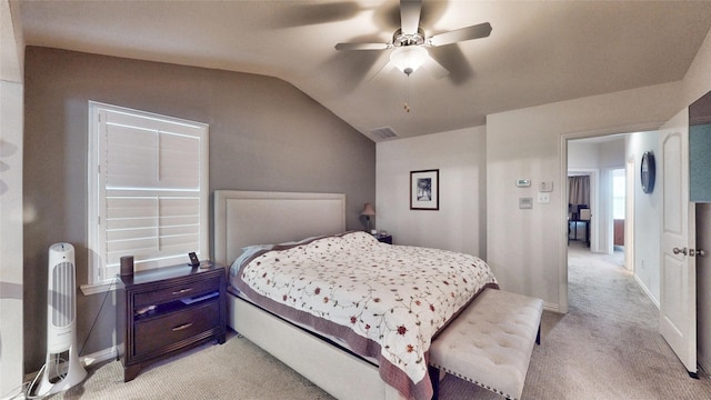 bedroom featuring lofted ceiling, light carpet, and ceiling fan