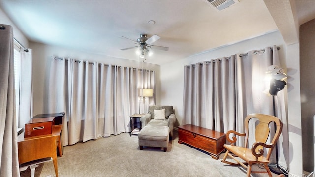 sitting room with carpet flooring and ceiling fan