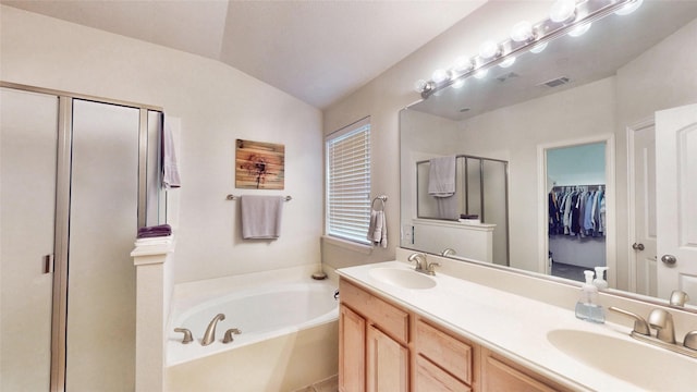 bathroom with vanity, vaulted ceiling, and shower with separate bathtub