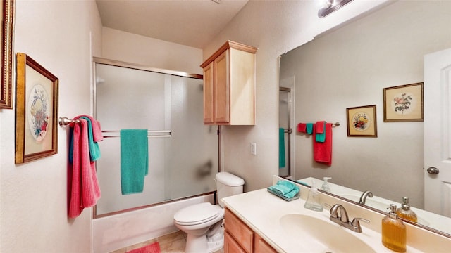 full bathroom with bath / shower combo with glass door, vanity, and toilet