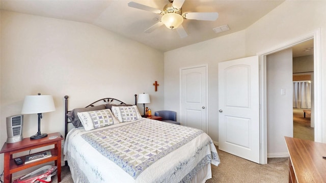 carpeted bedroom featuring lofted ceiling and ceiling fan