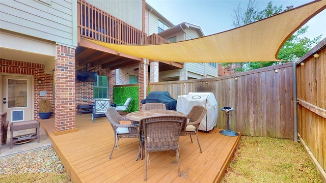 wooden deck featuring area for grilling