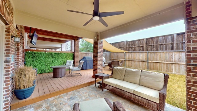 deck with ceiling fan, an outdoor living space, and grilling area