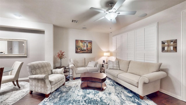 living room with dark hardwood / wood-style flooring and ceiling fan