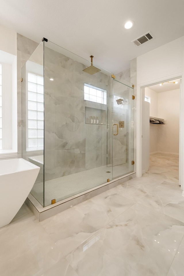 bathroom featuring separate shower and tub