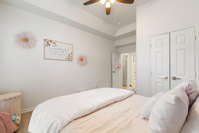 bedroom with hardwood / wood-style floors, ceiling fan, and a closet